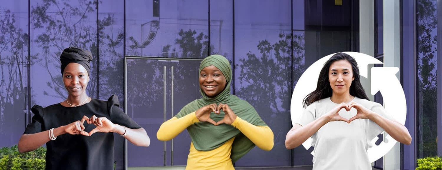 women making the shape of heart with hands