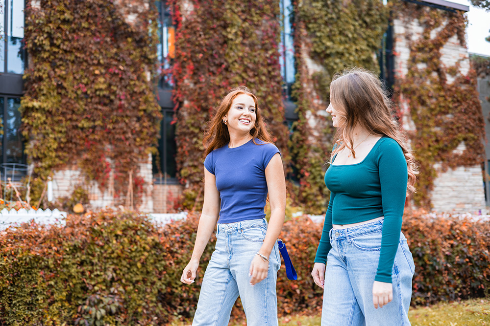 Students walking outside on campus in fall