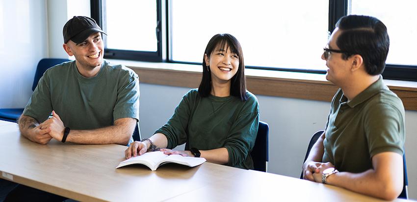 Three students sitting at a table together