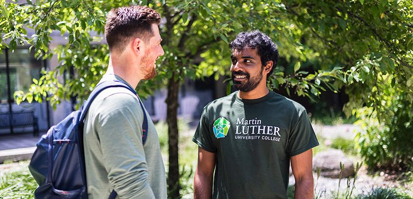 Two students standing outside together